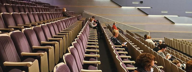 Theater interior with rows of seats and audience