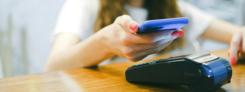 Person using card reader for payment